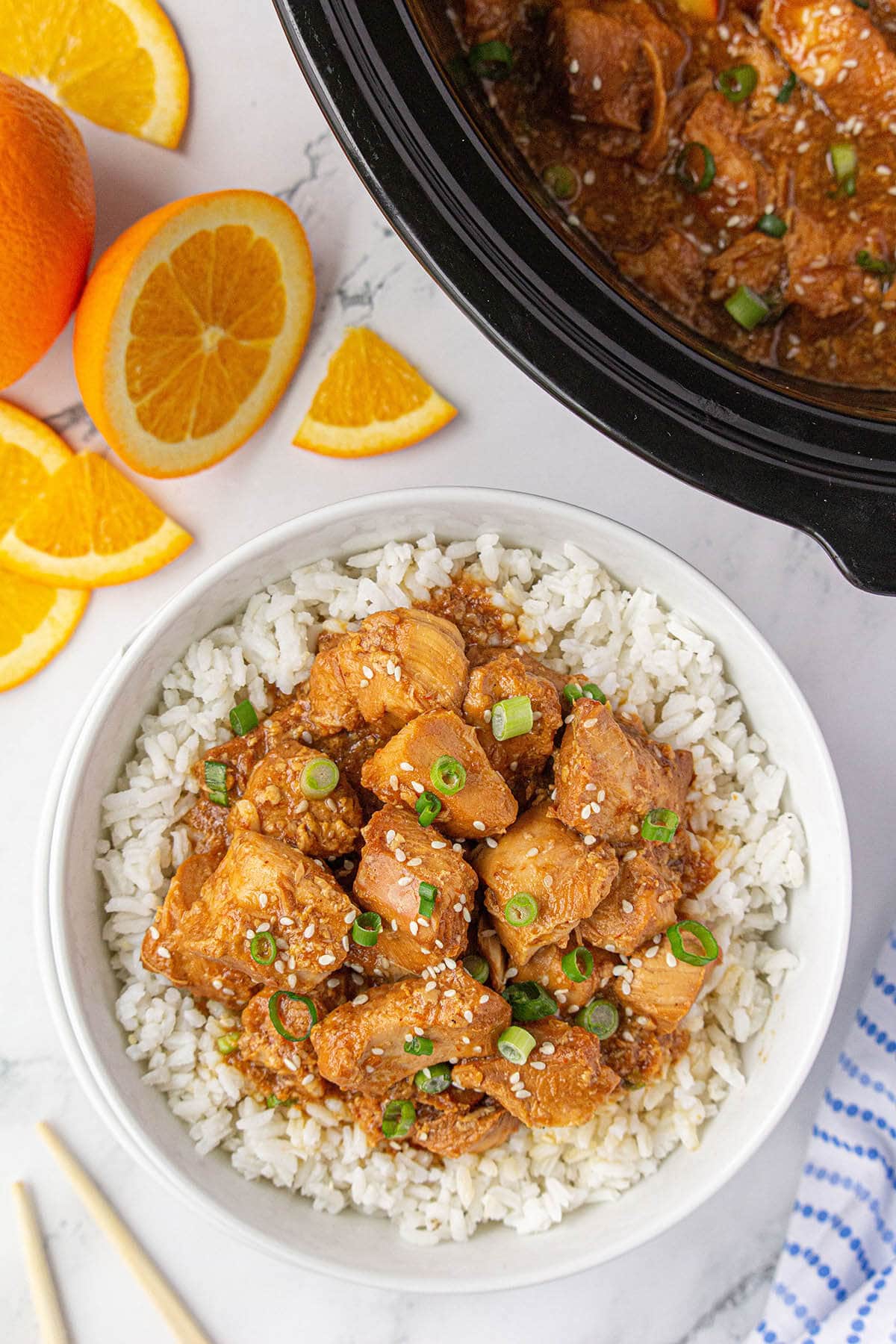 Bowl of slow cooker orange chicken over rice.