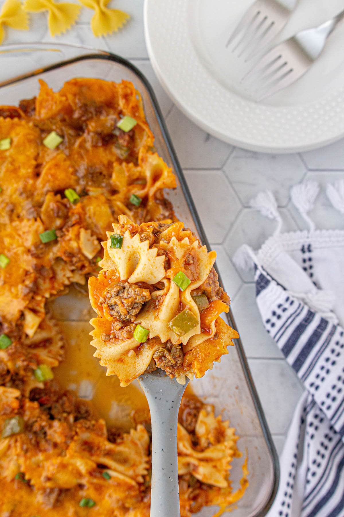 Sloppy Joe Casserole in a baking dish with a serving spoon.