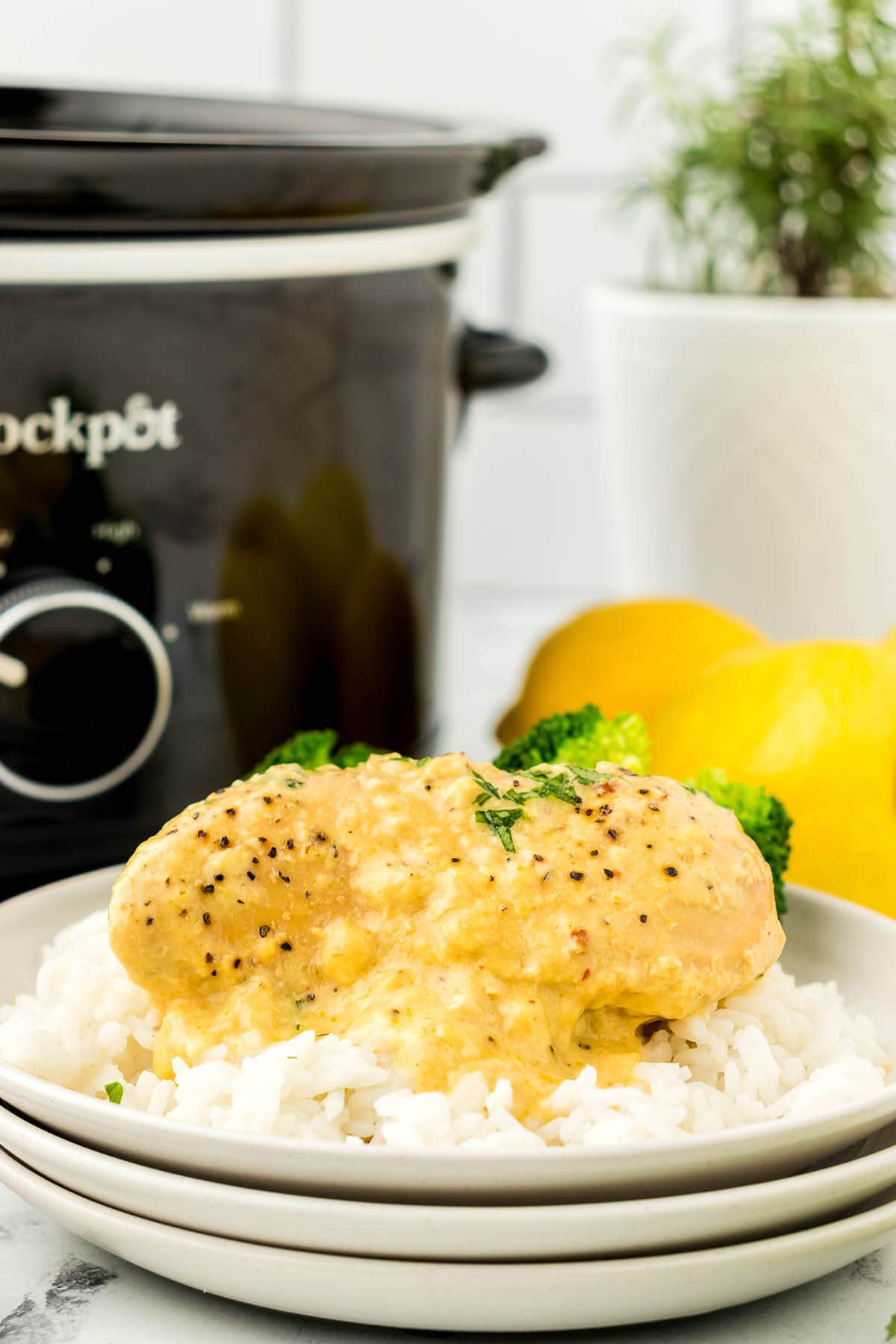 Crockpot Lemon Pepper Chicken on a plate over rice.