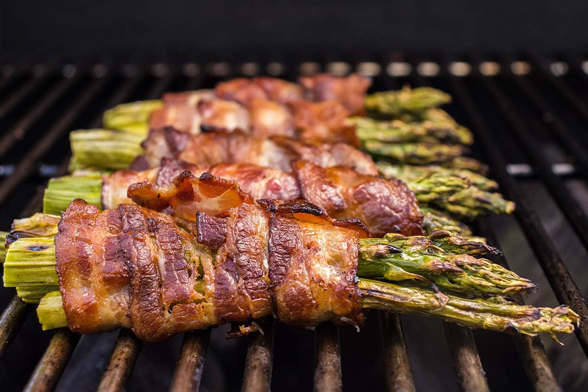 Close up of cooked asparagus on grill.