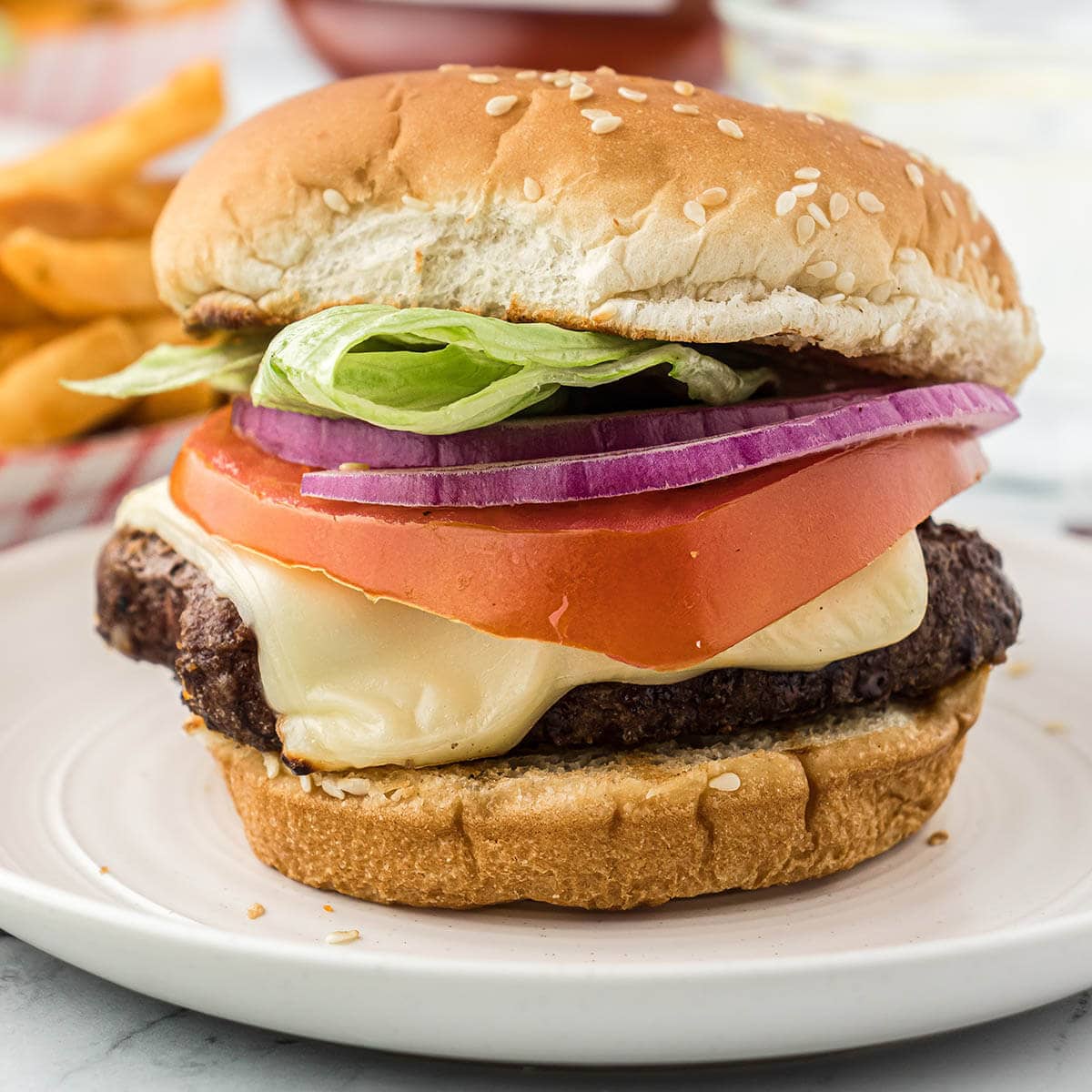 Grilled frozen hamburger on a plate.