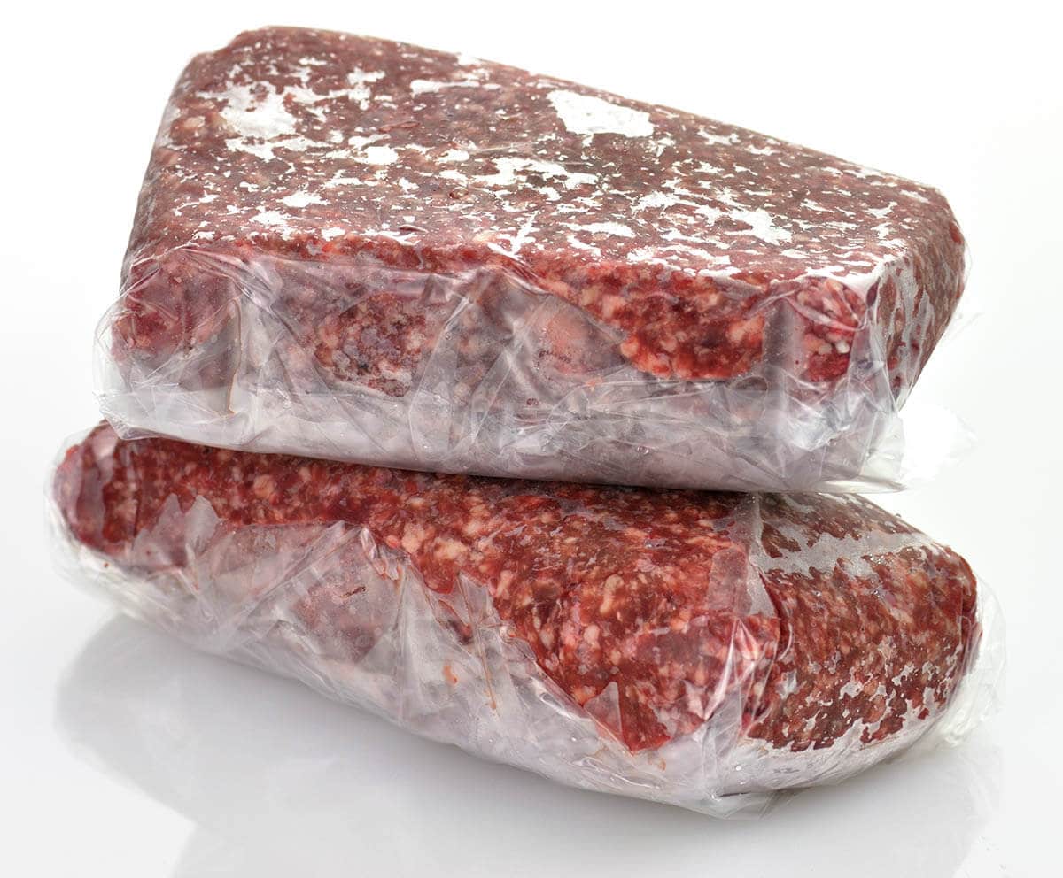 Frozen ground beef stored in a plastic package.