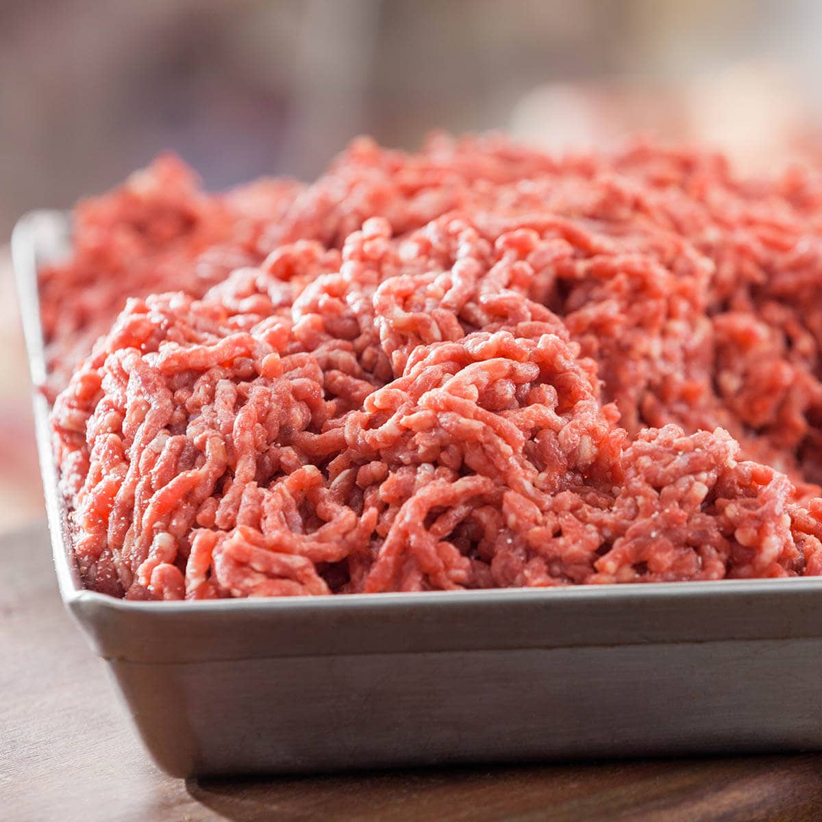 Ground beef is stored on a tray.