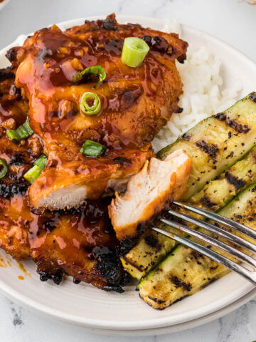 Grilled Huli Huli Chicken on platter with grilled zucchini.