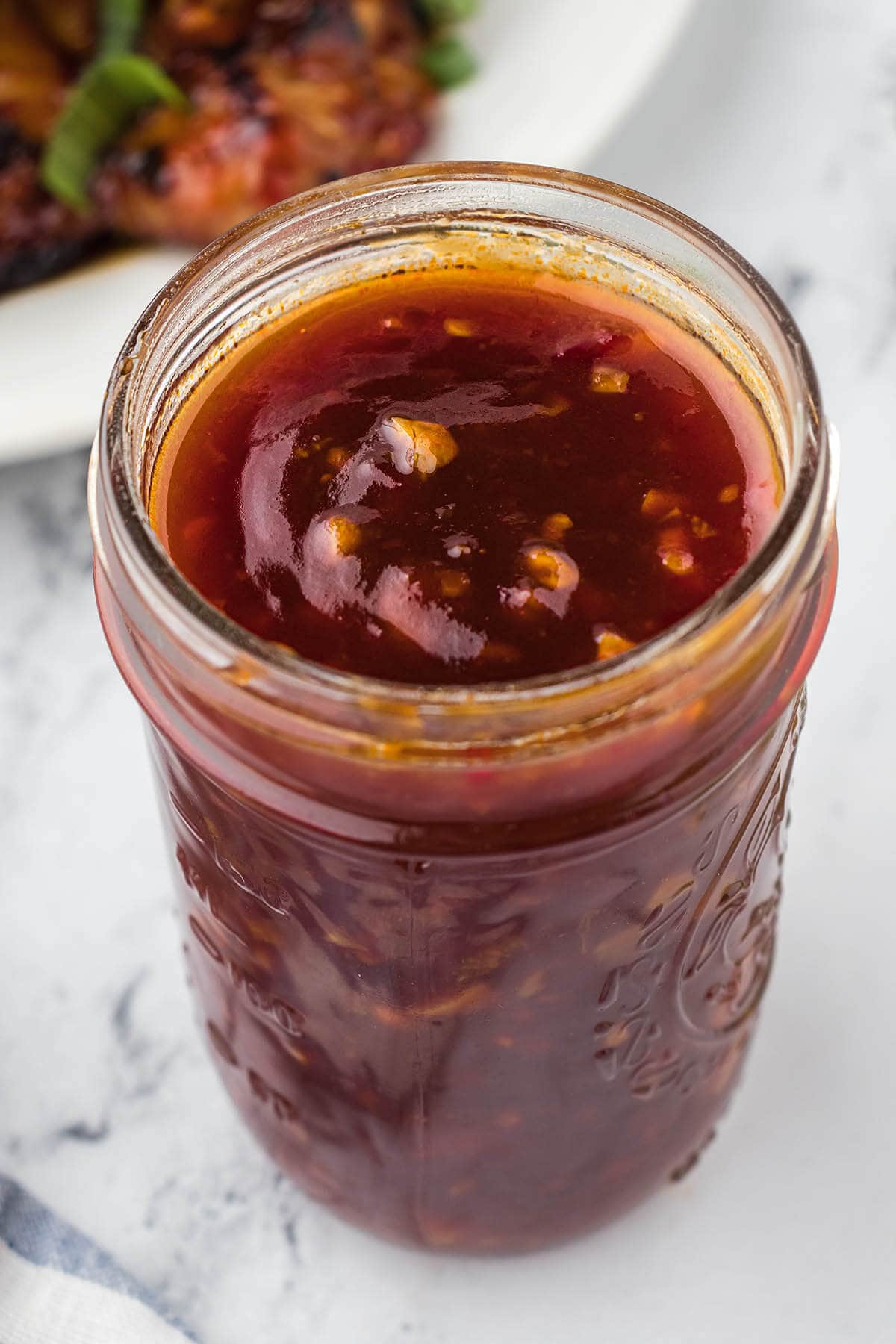 Overhead shot of mason jar filled with huli huli bbq sauce.