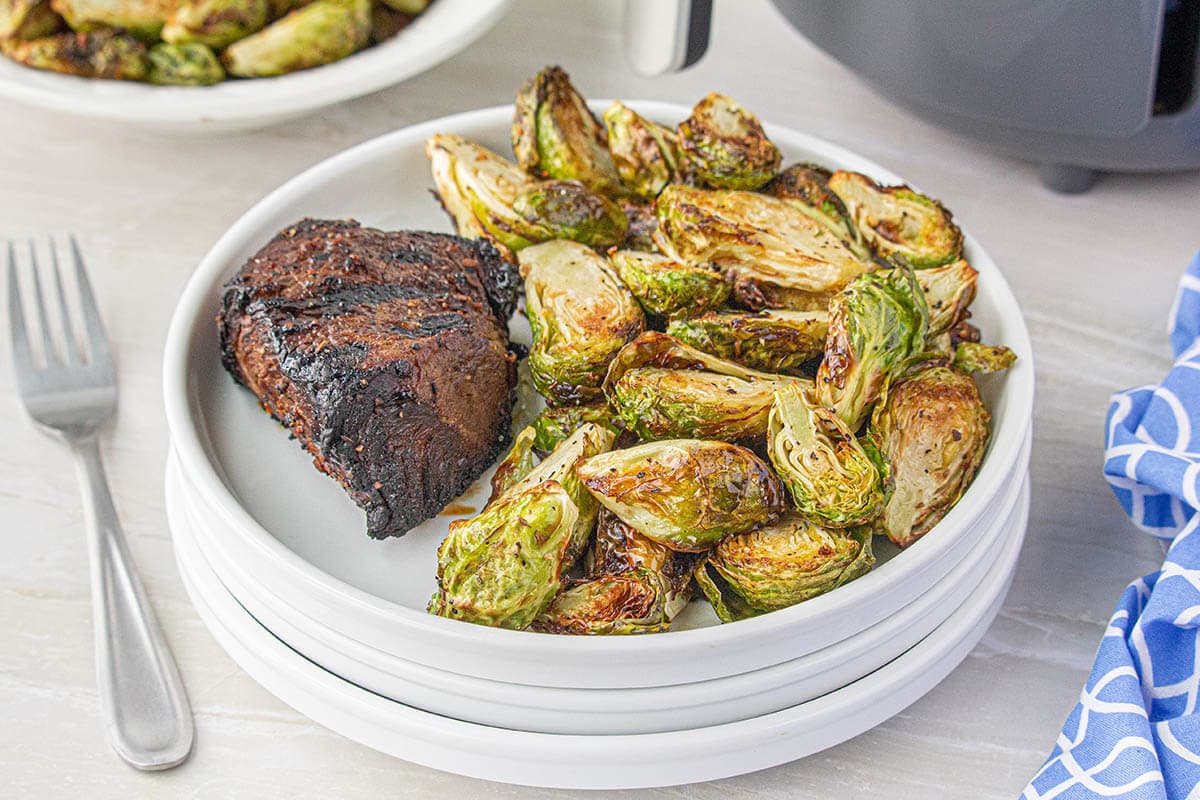 White plate filled with fried brussel sprouts