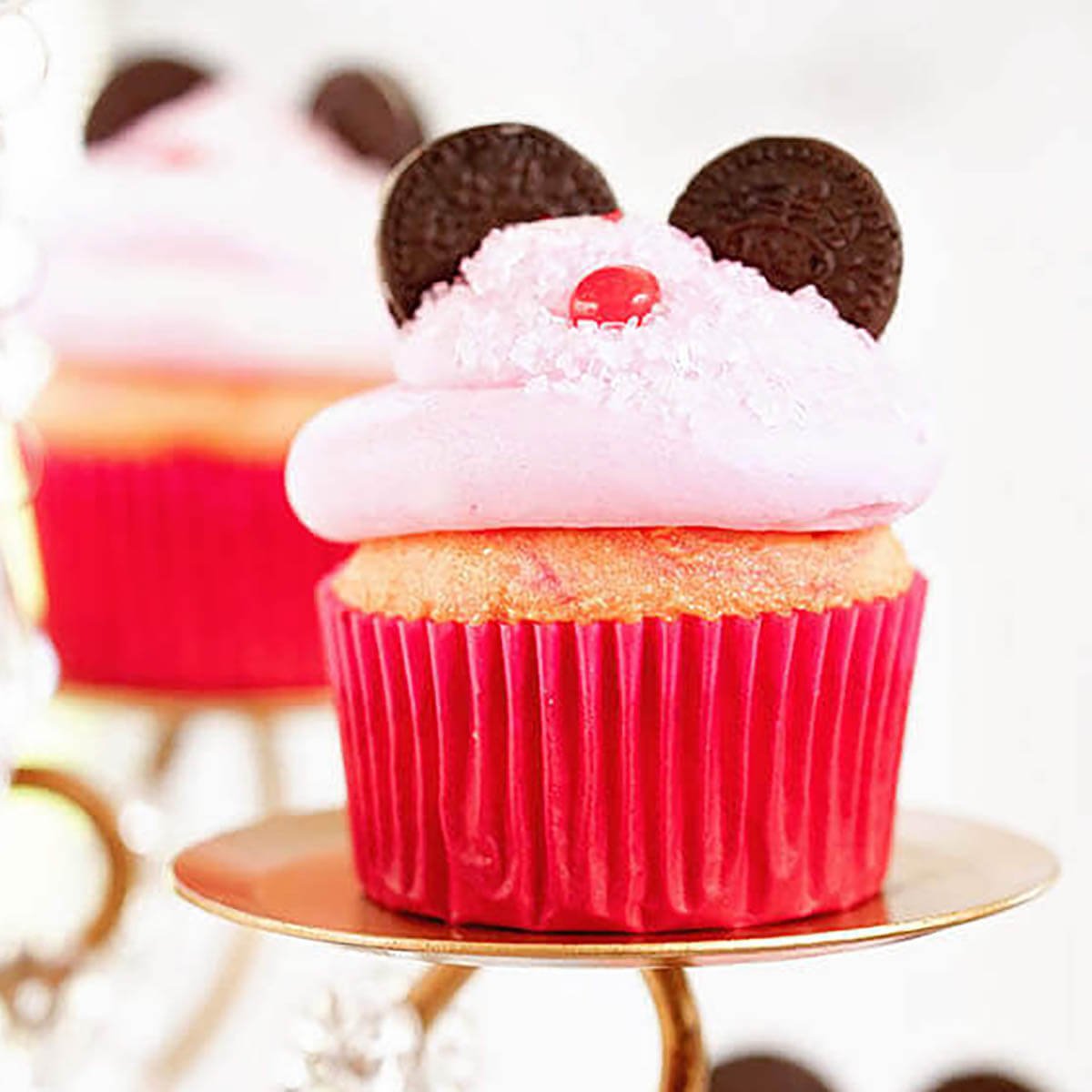 Minnie Mouse cupcakes on a cake stand.