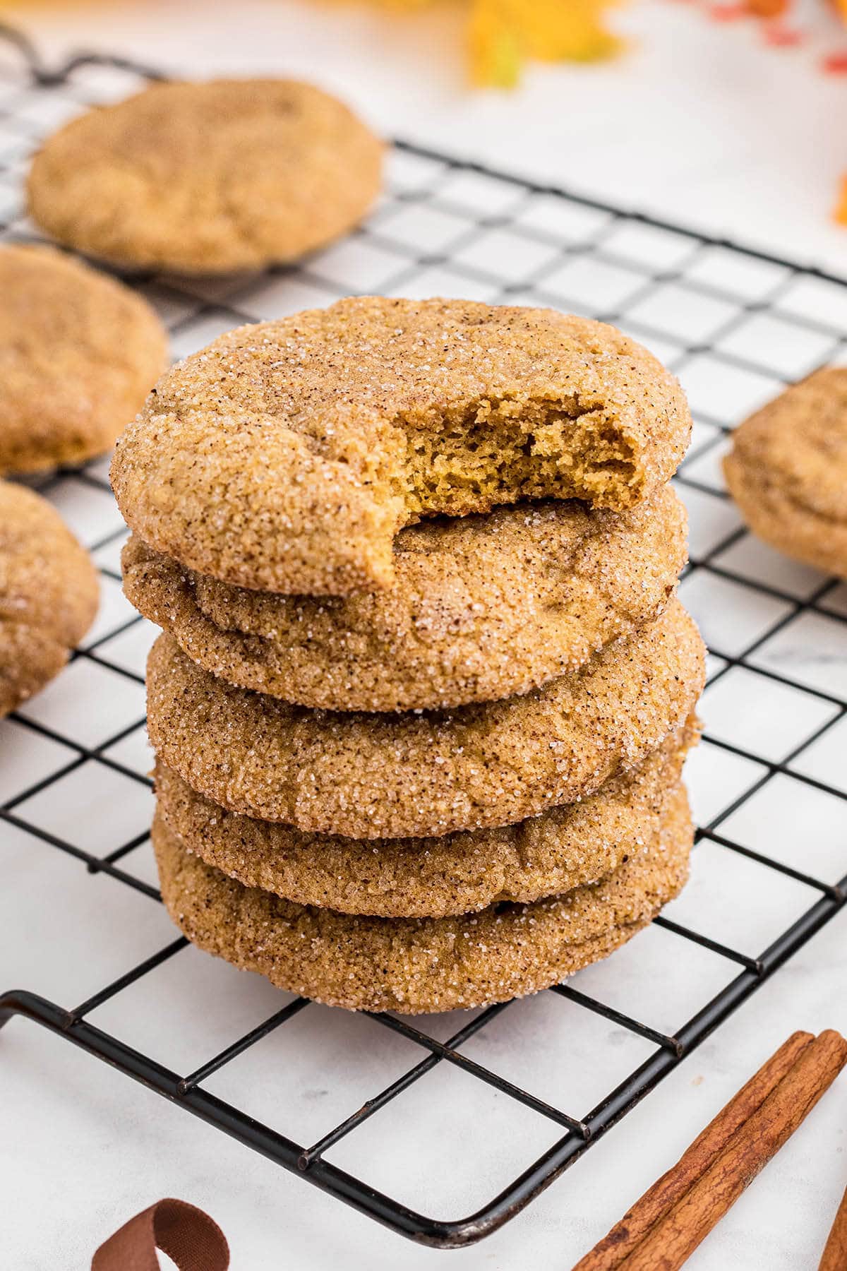 Stack of pumpkin spice cookies on a cooling rack.