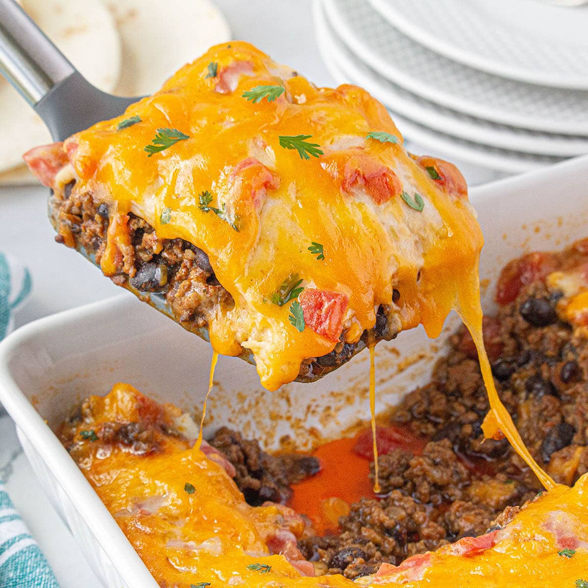 Firecracker casserole in baking dish with a serving spoon.