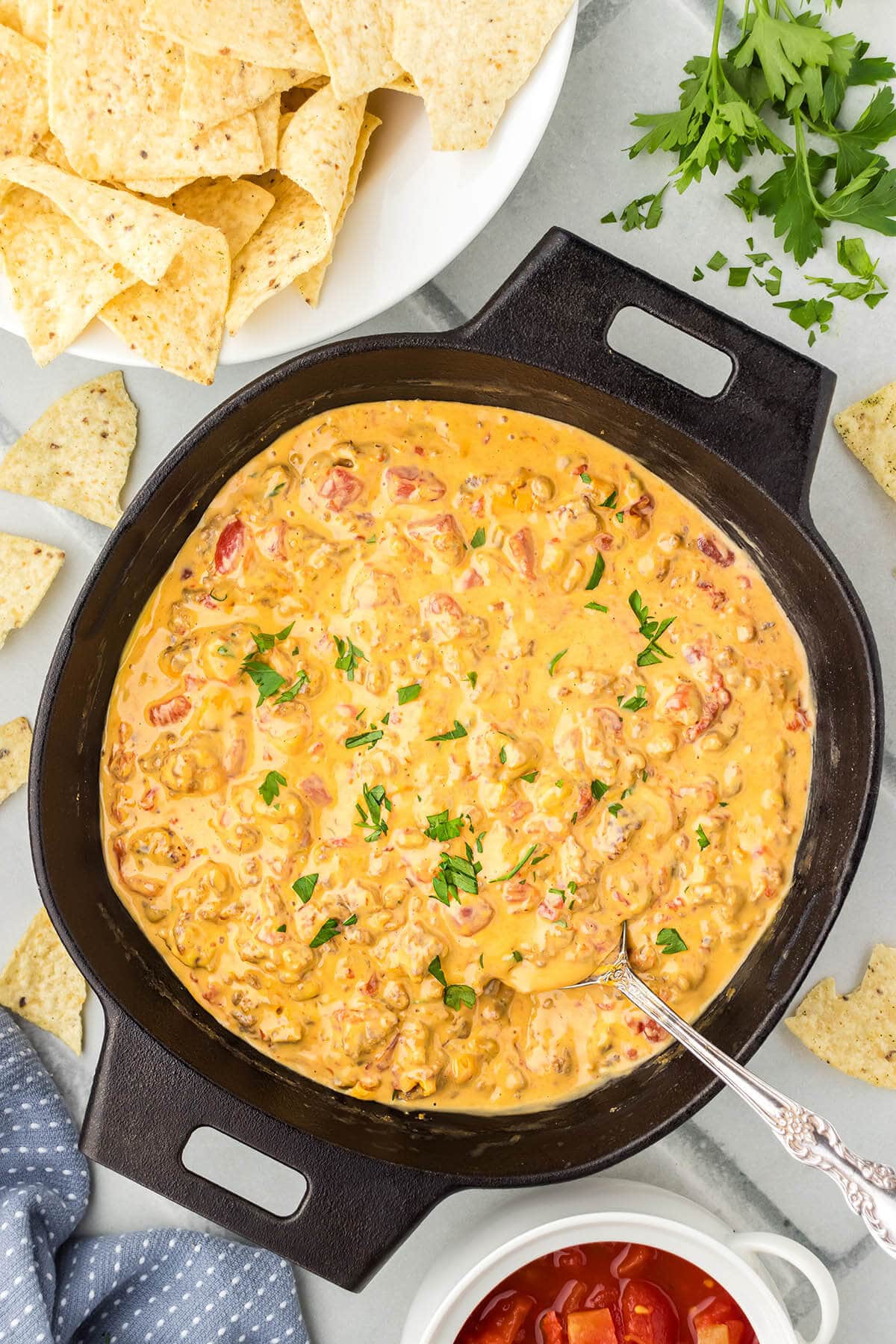 Sausage Rotel Dip in pan with spoon.
