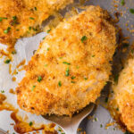 Crunchy Baked Ranch Chicken on sheet pan with serving spatula.