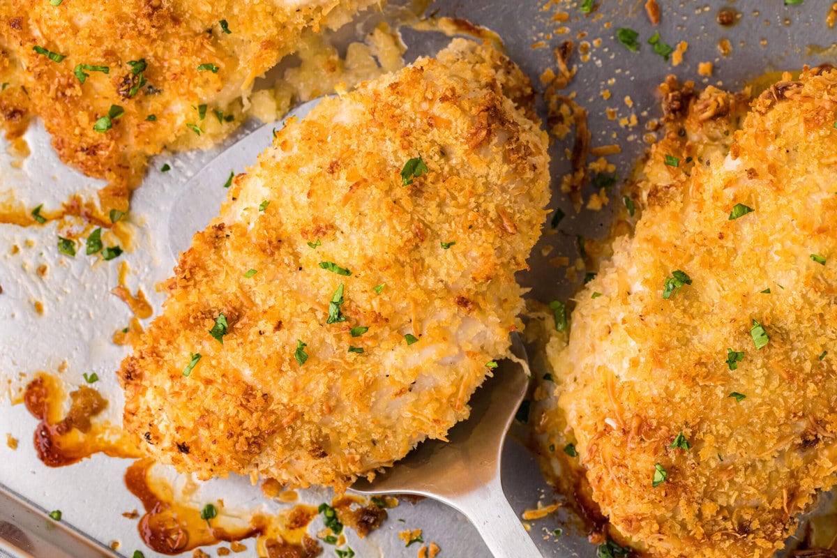 Crunchy Baked Ranch Chicken on a sheet pan with a spatula for serving.