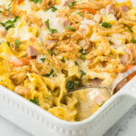 Ham and Noodle Casserole in a baking dish, with a serving spoon.