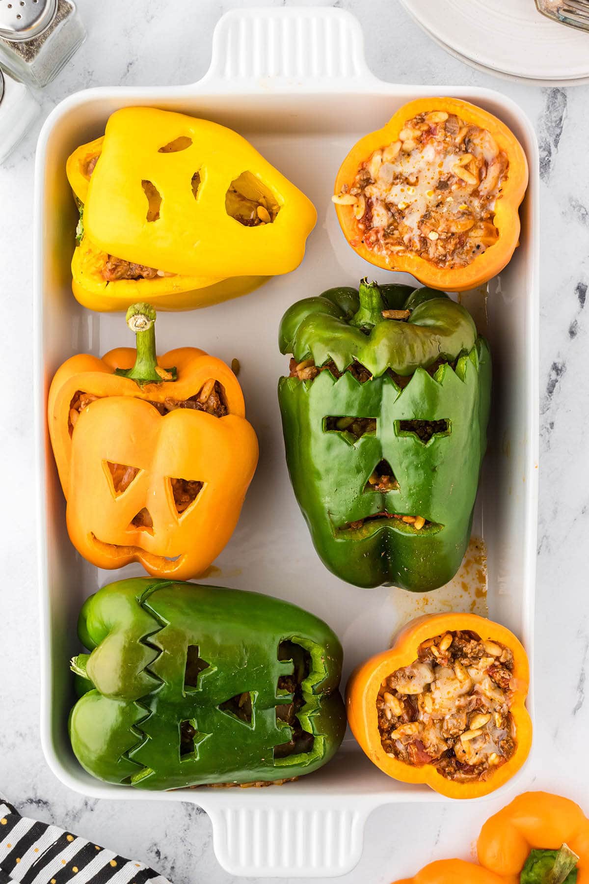 Jack o lantern, Frankenstein and Scream carved stuffed halloween bell peppers.