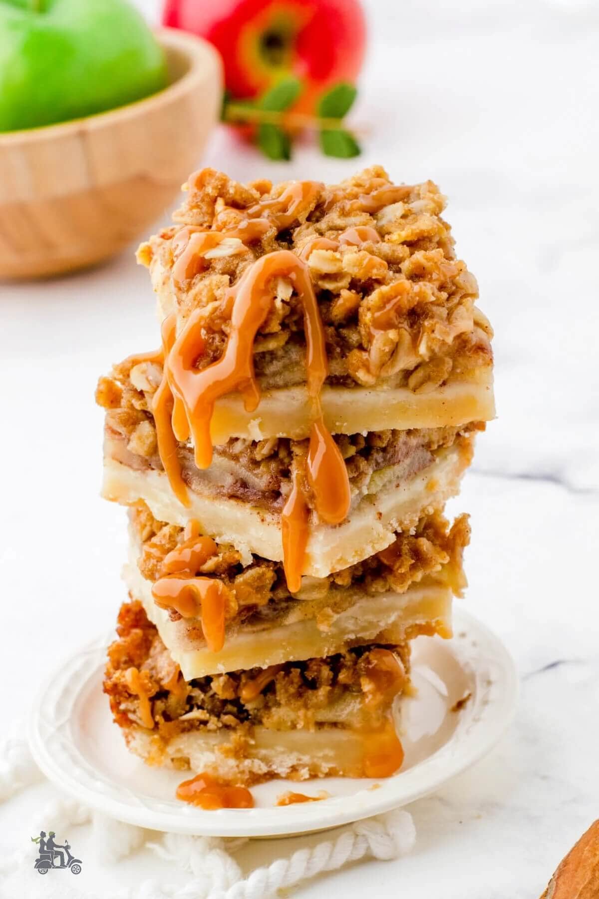 A stack of salted caramel apple pie bars on a plate.