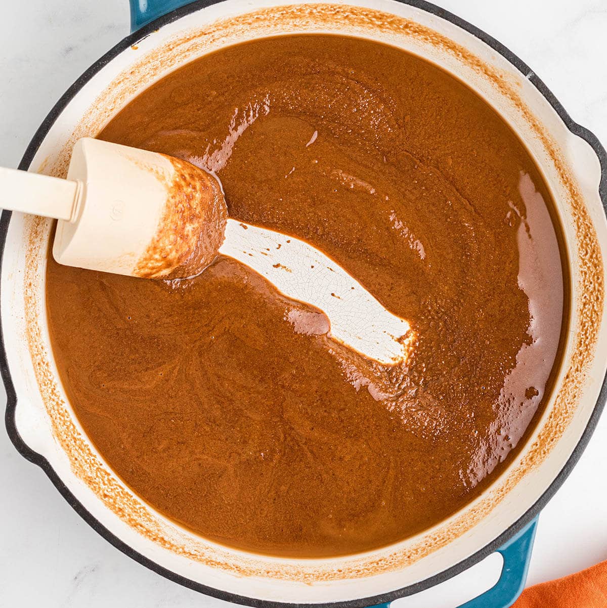 Basic Roux recipe being cooked in a skillet. The roux has been cooking a while and is very dark.