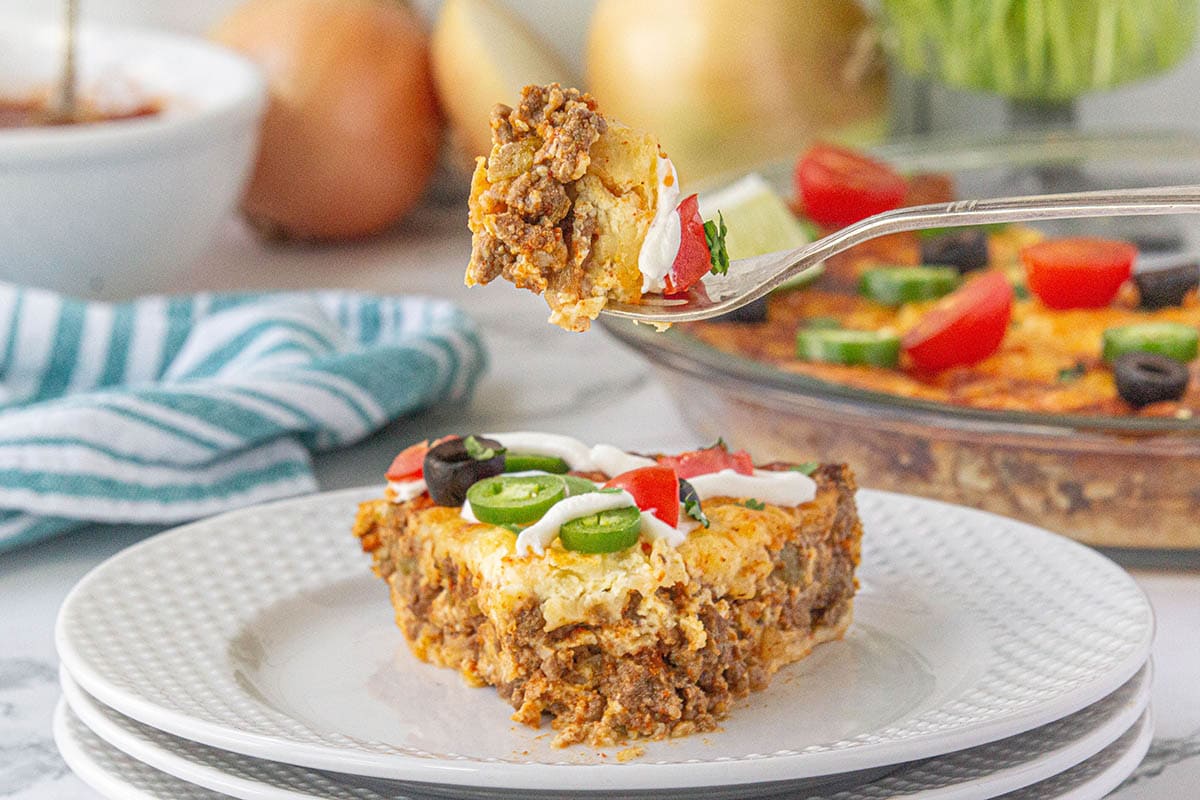 Slice of Bisquick Taco Pie on a plate with a fork.