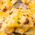 Chicken Pierogi Casserole in a baking dish with a serving spoon. With print overlay.