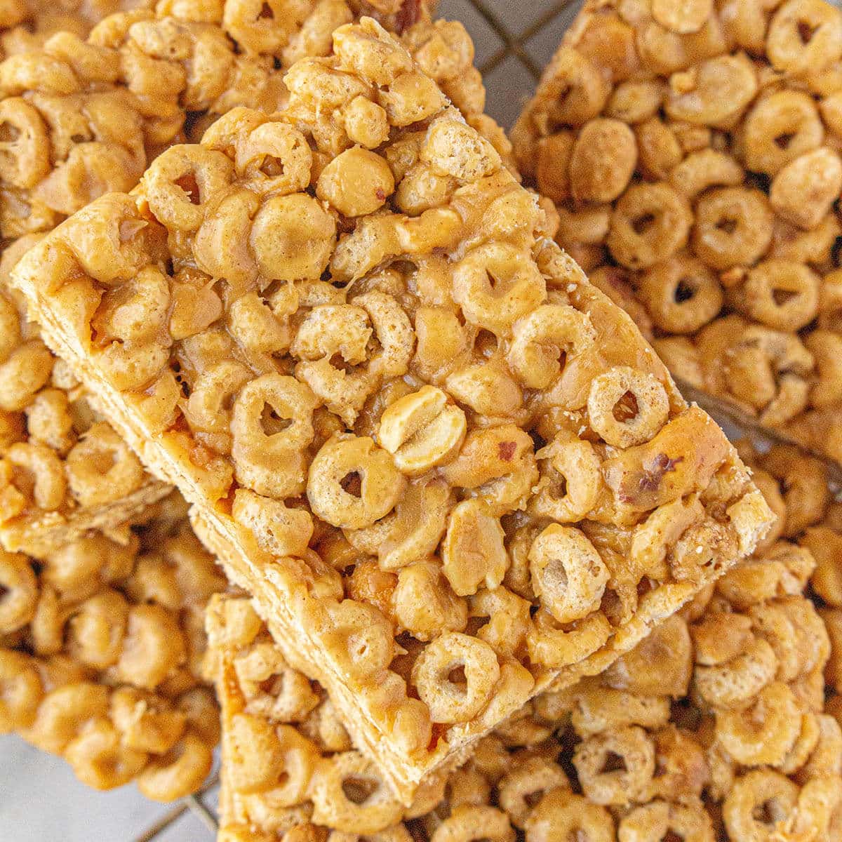 A pile of peanut butter Cheerio bars on a plate.