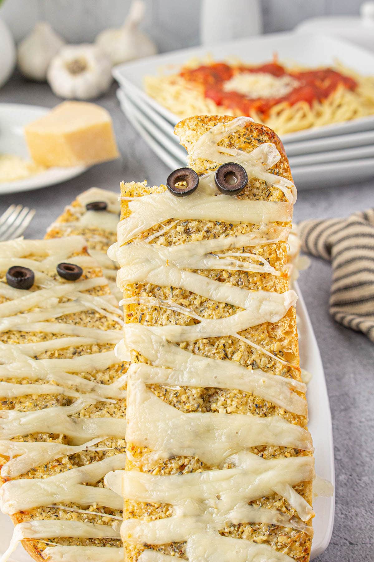 Crispy, mummy cheesy garlic bread on a platter.
