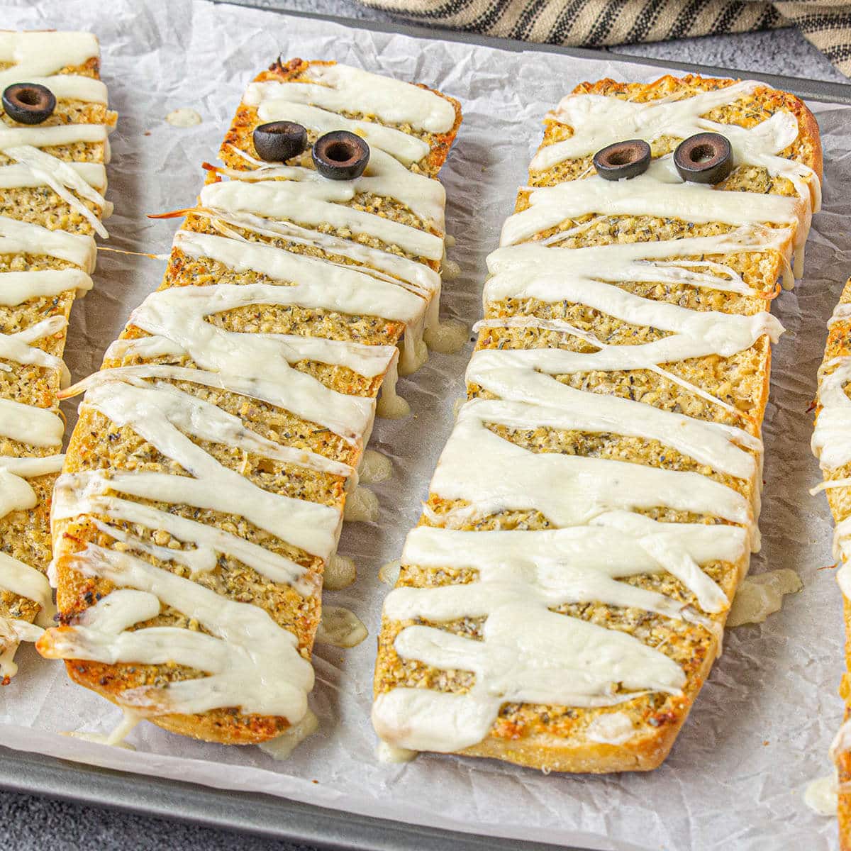 Crispy Halloween Garlic Bread on a baking sheet.