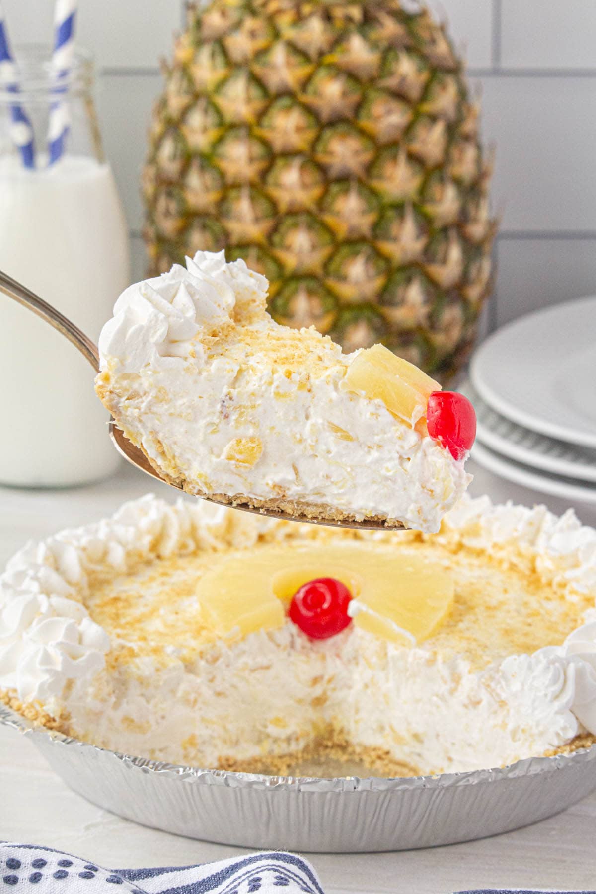 Sliced Pineapple Cream Cheese Pie, with one serving on a spatula ready to dish up.