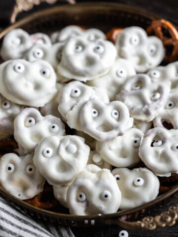 A platter filled with white chocolate dipped pretzel ghosts.