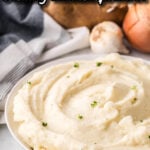 Creamy mashed potatoes in a bowl. With print overlay for social media.