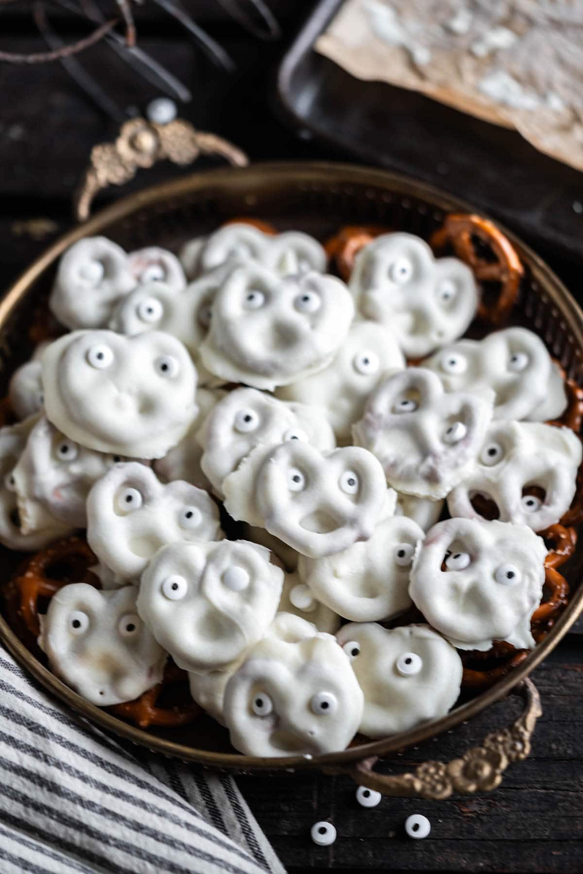 White Chocolate Dipped Pretzel Ghosts on a platter.