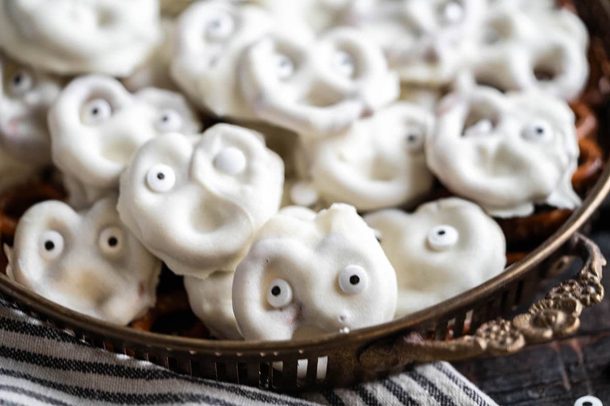 A platter filled with little white chocolate pretzel ghosts.