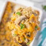 Beef and rice casserole in a baking dish and on a serving spoon.