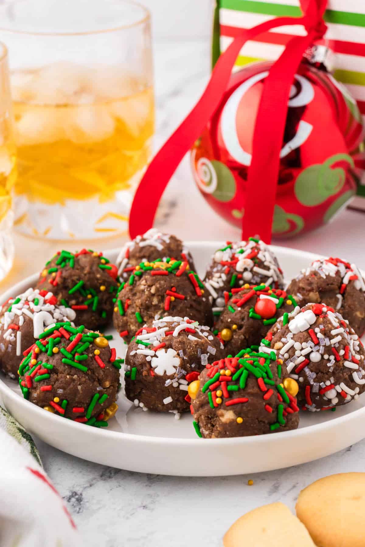 Bourbon balls decorated for Christmas on a plate.
