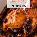 Catalina cranberry chicken in a baking dish with a serving spoon. With print overlay for Pinterest.