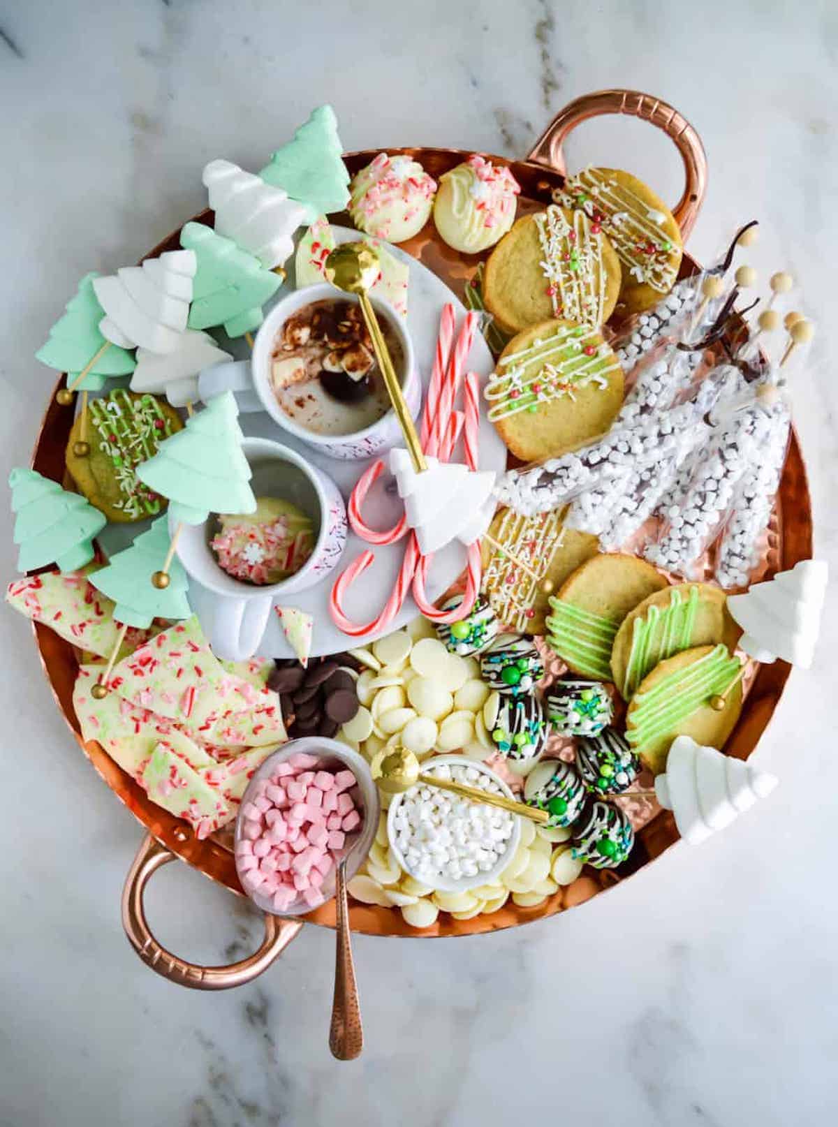 Hot chocolate charcuterie board filled with chocolates and candy.