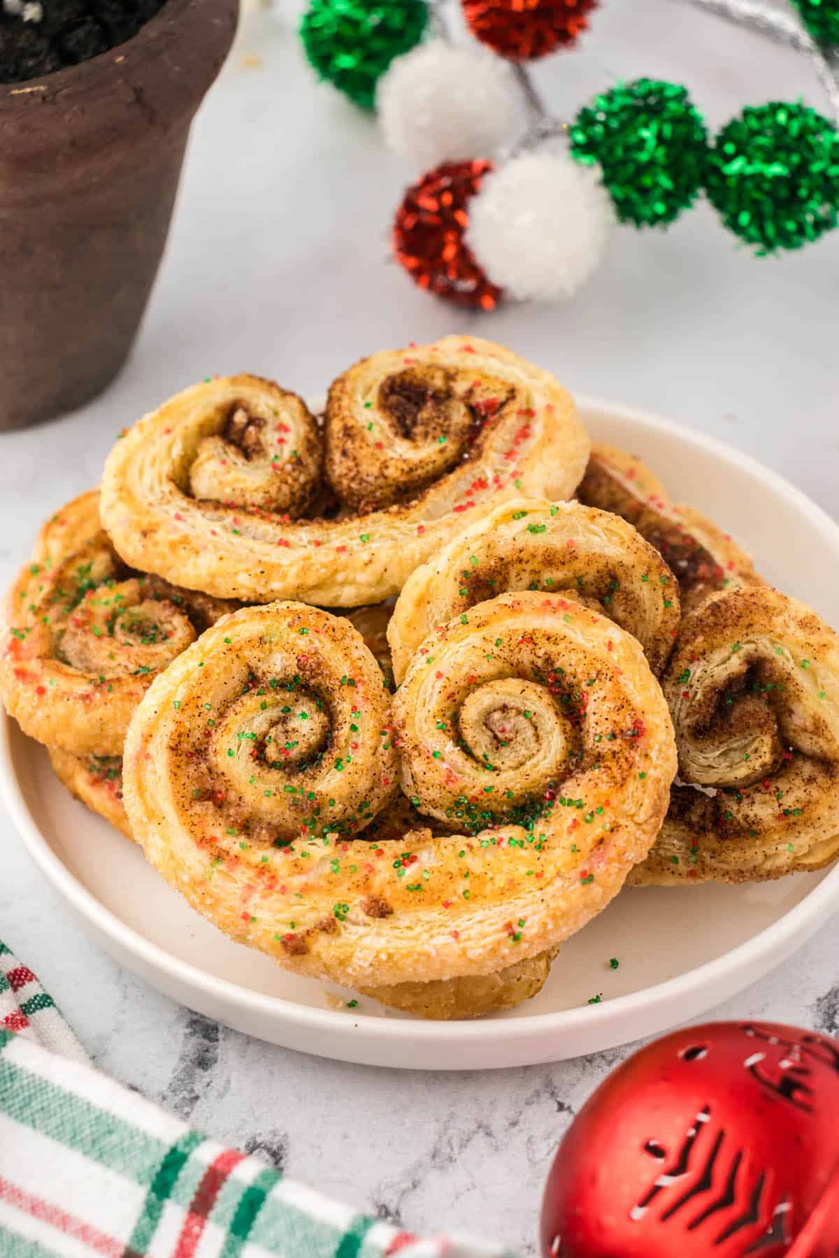 French Palmiers piled on a plate ready for a holiday cookie exchange.