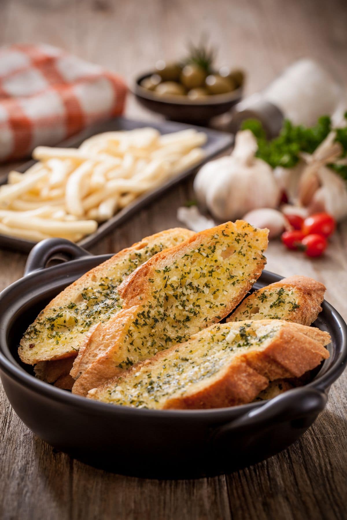 Toasted garlic bread in a bowl for serving.