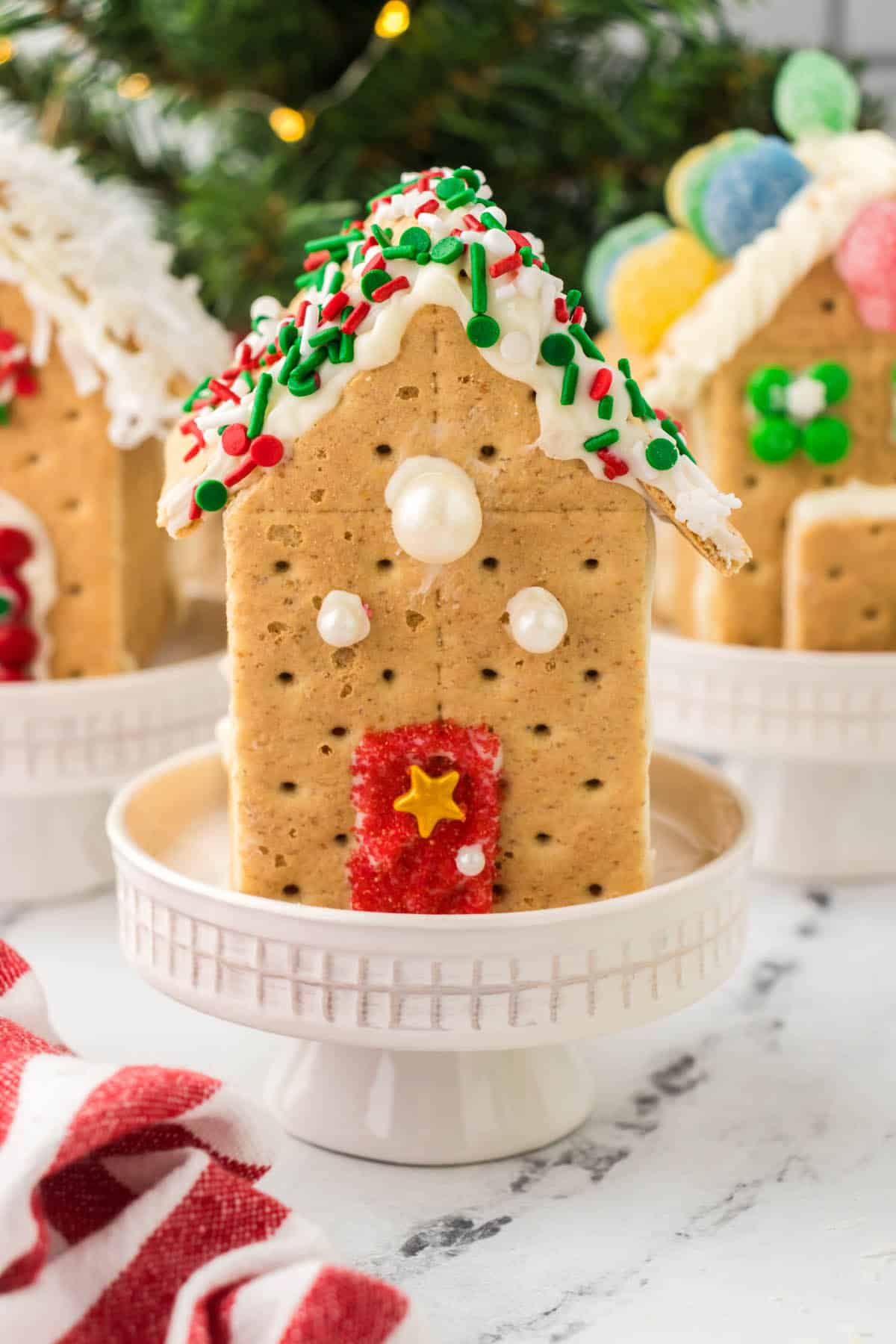Pretty Graham Cracker Gingerbread Houses decorated for the holiday season.