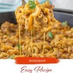 Cheesy Homemade Hamburger Helper in a cast iron skillet, with a serving spoon taking a big scoop. With print overlay for Pinterest.