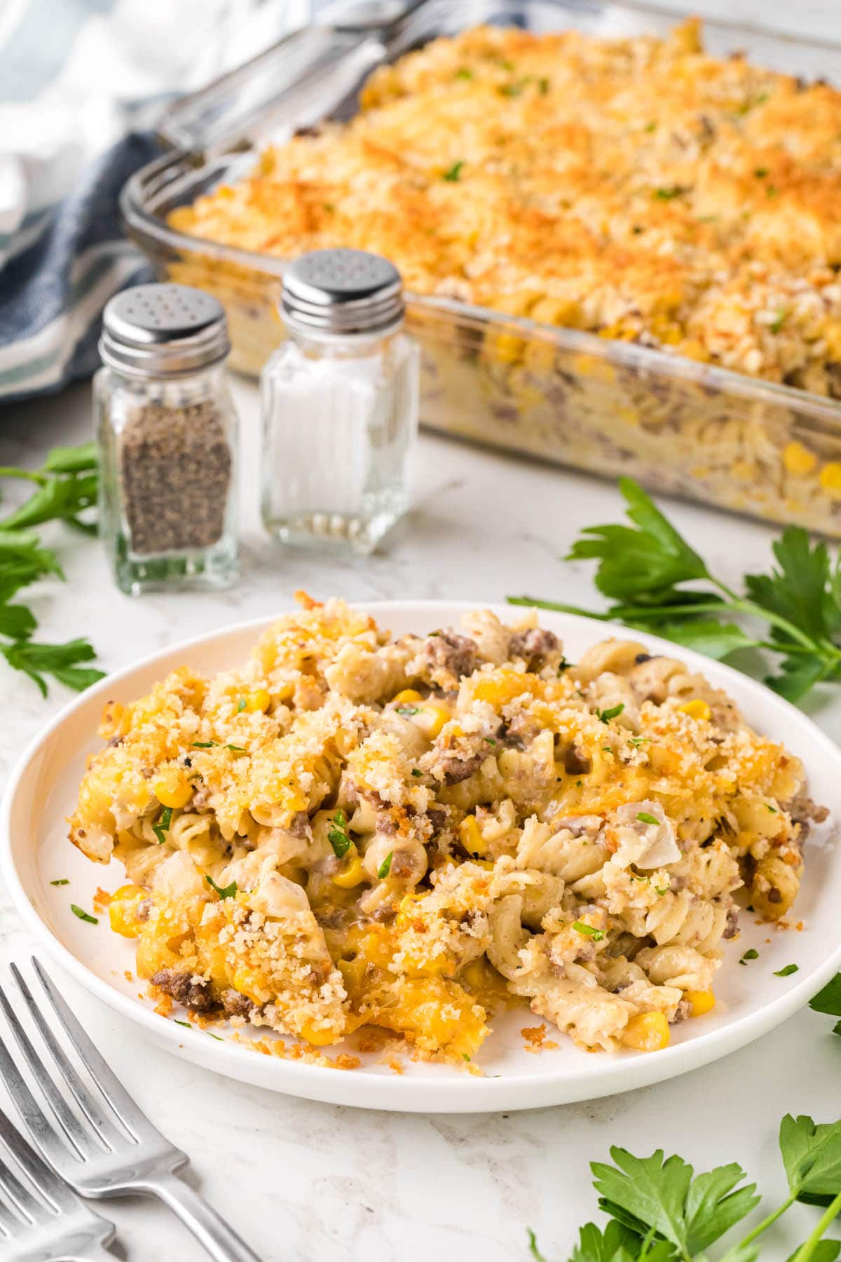 Plate filled with pasta with the casserole dish in the background.