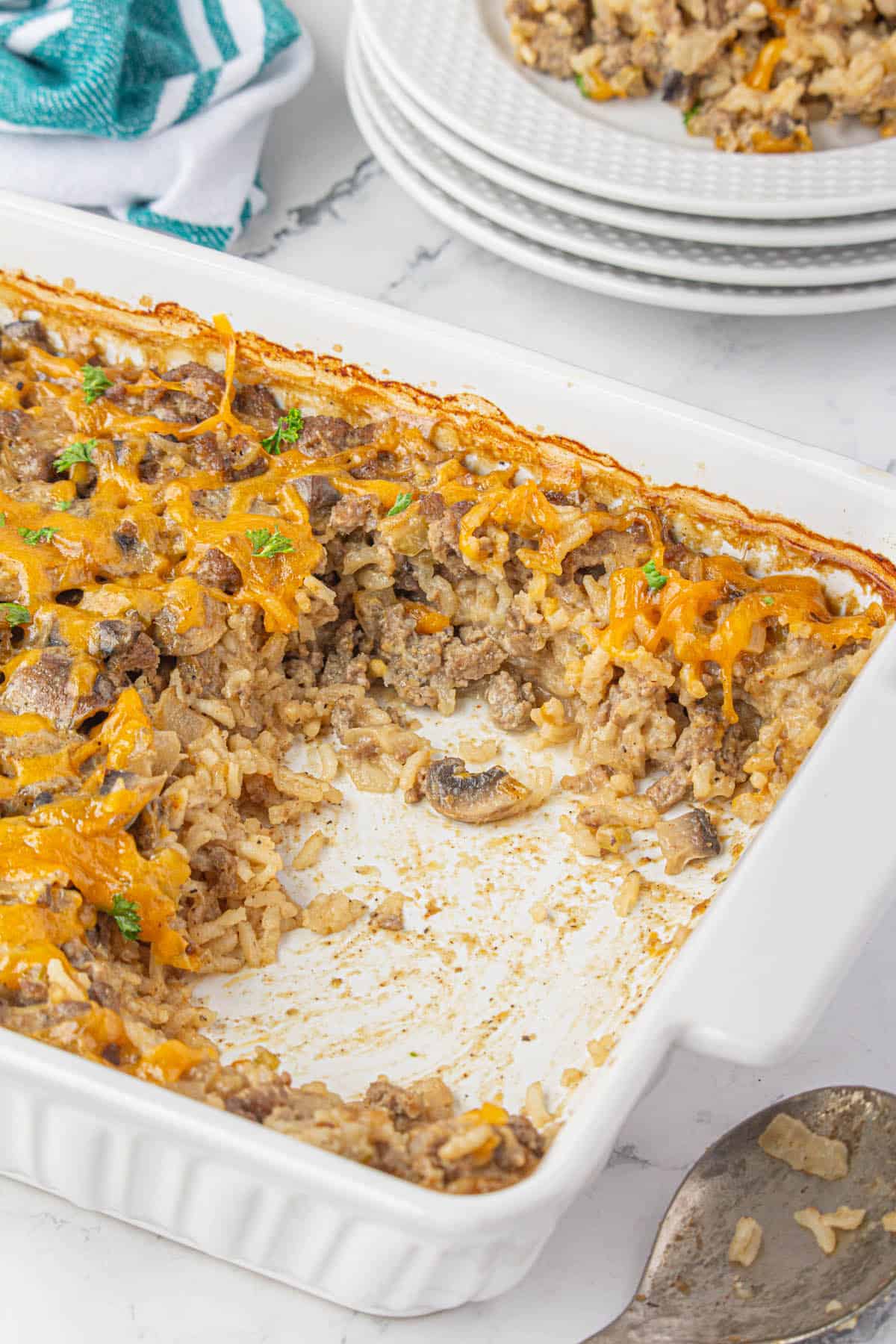 Beef and rice casserole in a baking dish. There have been several servings removed.