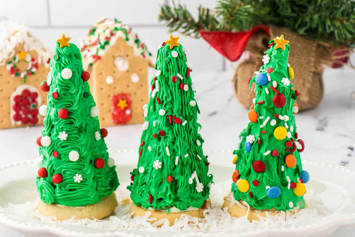 Christmas trees made out of sugar cones decorated and on a platter.