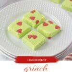 A plate filled with slices of Grinch Fudge, with print overlay for Pinterest.