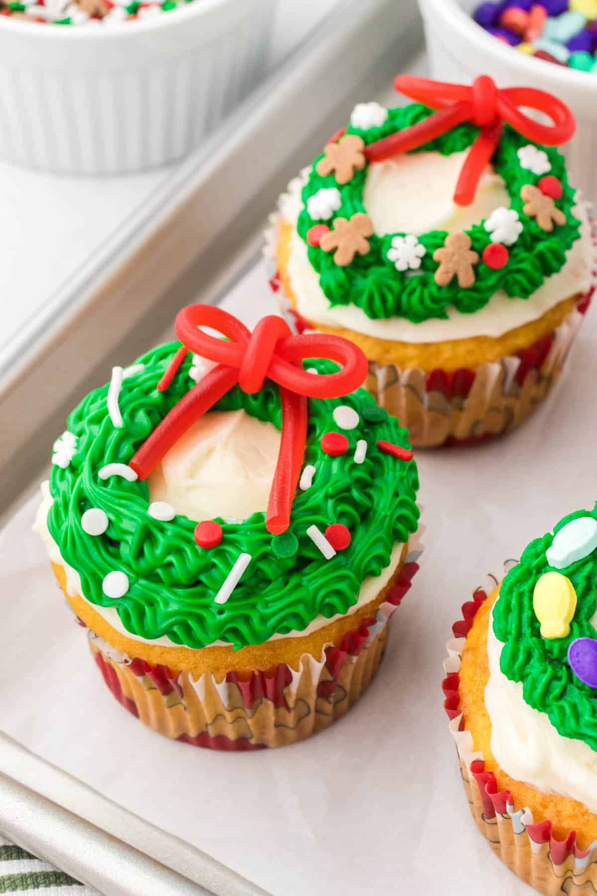 Holiday Christmas Wreath Cupcakes displayed on a cookie sheet.