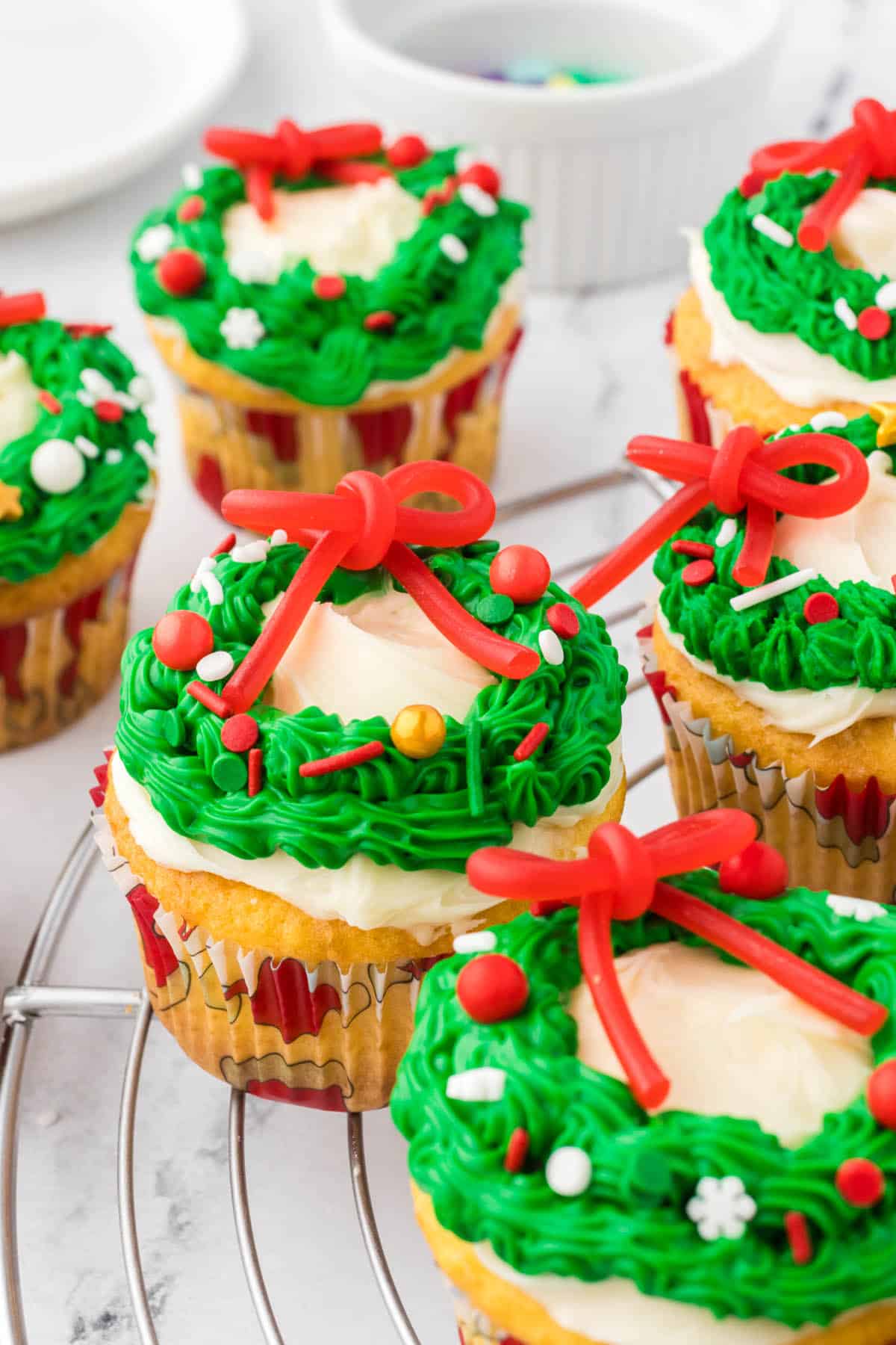 Pretty Christmas Wreath Cupcakes on a cooling wrack.