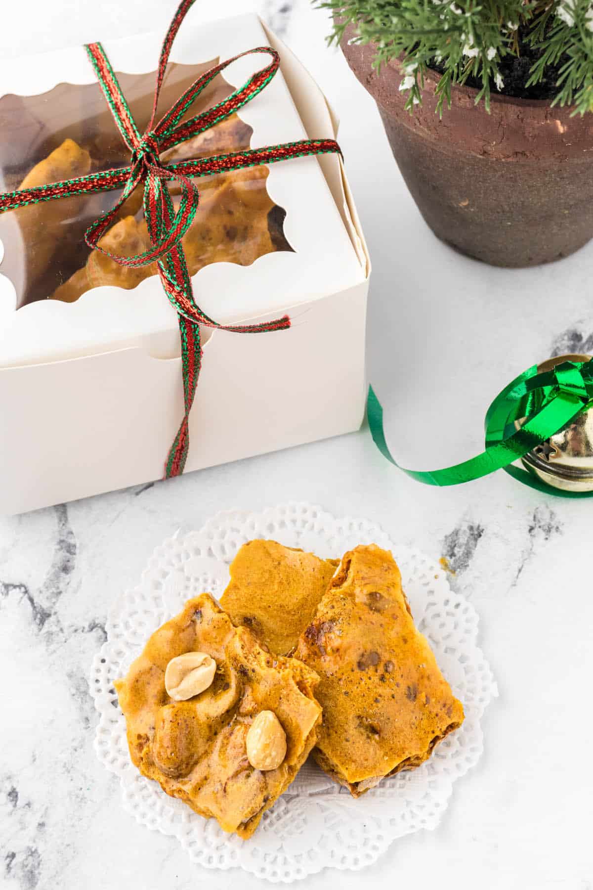 Peanut brittle packaged as a gift and a small platter filled with candy.