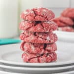 Red Velvet Crinkle Cookies stacked on a plate.