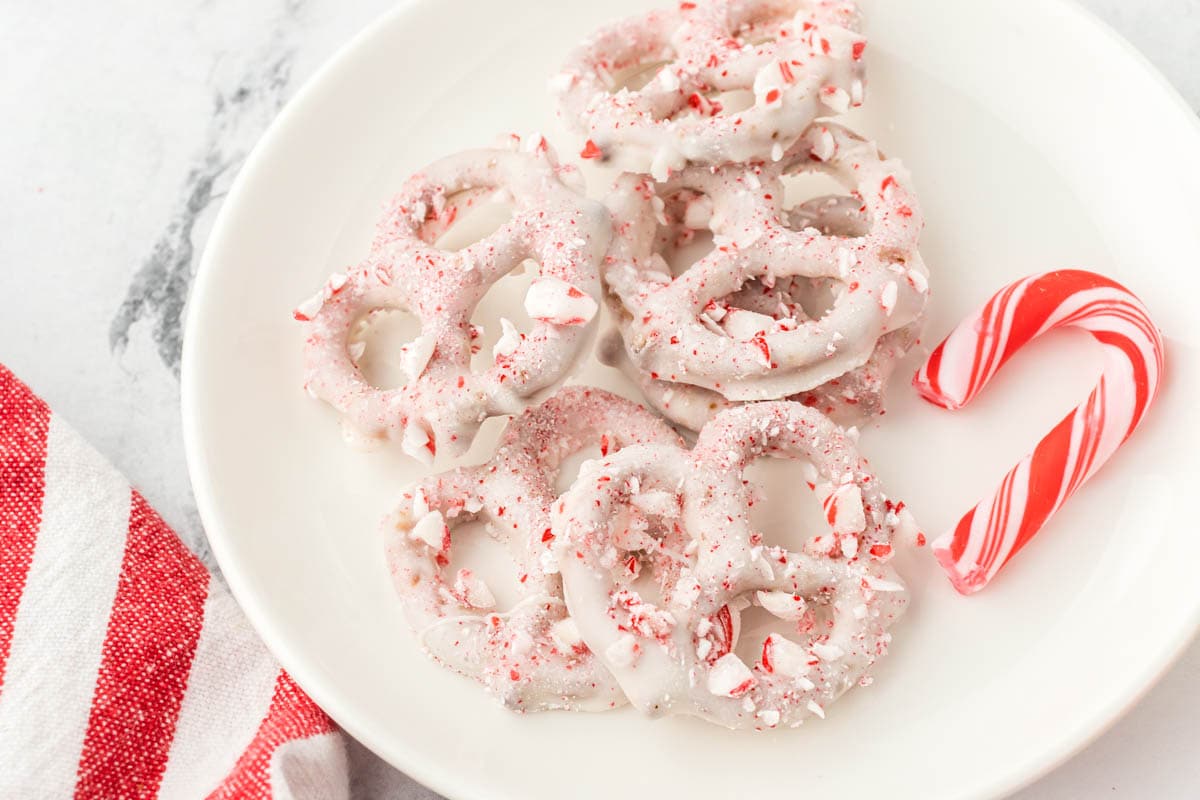 Chocolate pretzels on a platter with a candy cane.