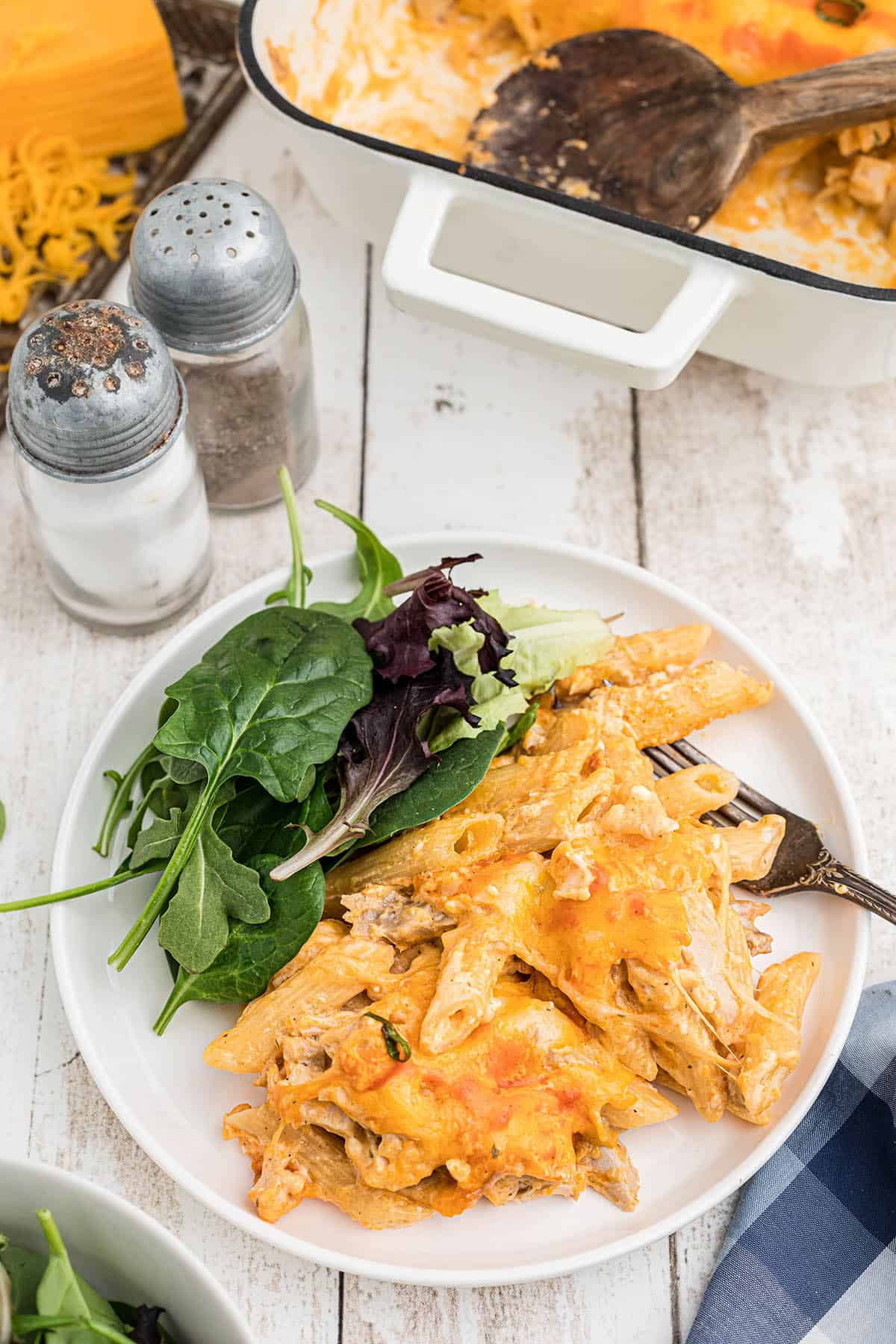 Cheesy Buffalo Chicken Pasta Bake on a plate with a salad.