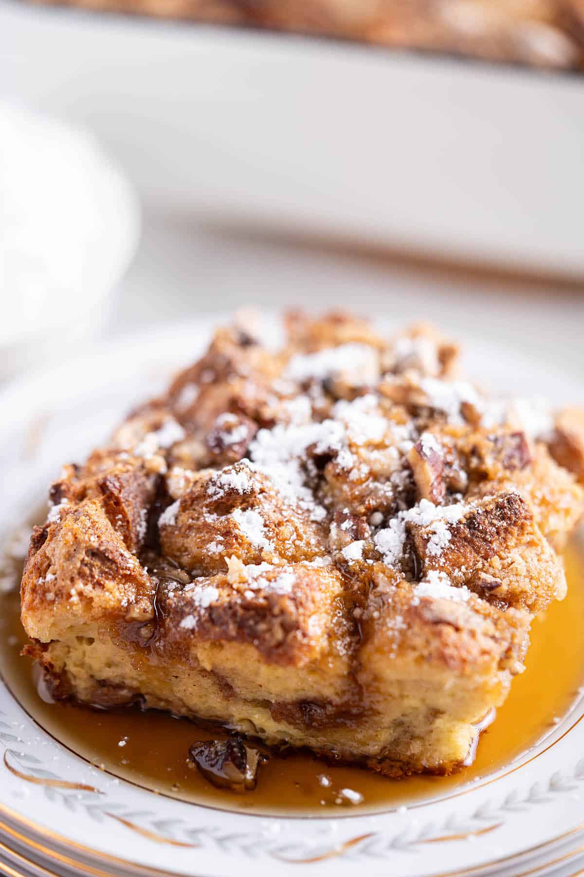 French Toast Casserole on a plate drizzled with maple syrup.