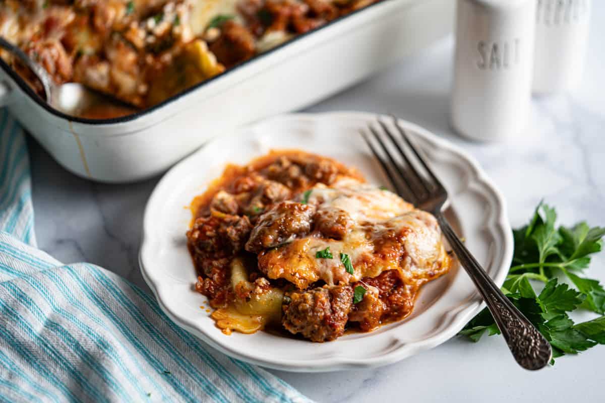 Meaty Ravioli Casserole dished up on a plate with a fork.